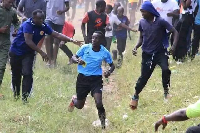 A match official running for his life during Compel vs GFE 105 game at Ilala Panpaper Stadium